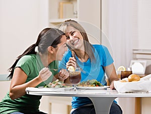 Friends eating healthy lunch and laughing