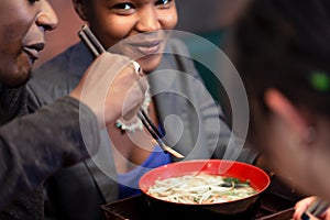 Friends eating noodle soup in Japanese Restaurant