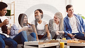 Friends eating pizza. Teenagers having fun at home party