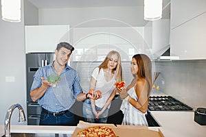 Friends eatting in a kitchen photo