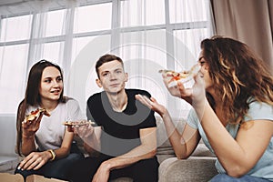 Friends enjoy pizza and chatting, eat tasty food