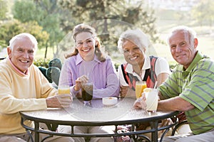 Friends Enjoying A Beverage By A Golf Course