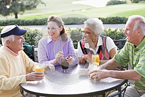 Friends Enjoying A Beverage By A Golf Course photo