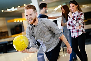 Friends enjoying bowling at club