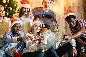 Friends Enjoying Christmas Drinks In Bar