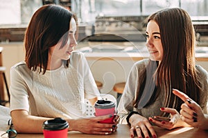 Friends enjoying coffee and friendly talk at cafe