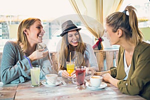 Friends enjoying in conversation and drinking coffee.