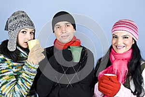 Friends enjoying a cup of hot drink and heat up