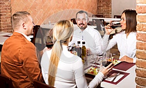 Friends enjoying delicious meal in country restaurant