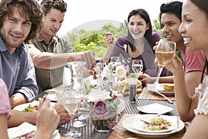 Friends Enjoying Dinner Party Outdoors