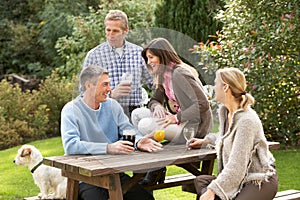 Friends Enjoying Drink In Pub Garden