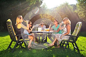 Friends enjoying garden party on a sunny afternoon photo