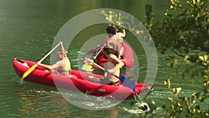 Friends enjoying riding canoe on river