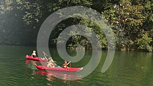 Friends enjoying riding canoe on river