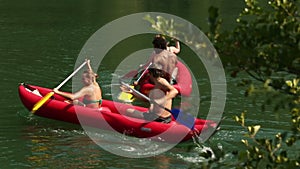 Friends enjoying riding canoe on river