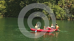 Friends enjoying riding canoe on river