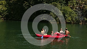 Friends enjoying riding canoe on river