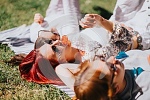 Friends enjoying a sunny day in the park with colorful lollipops