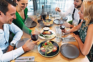 Friends enjoying a tasty dinner in a fancy restaurant