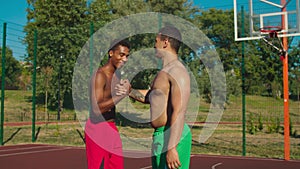 Friends exchanging handshake after basketball game