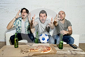 Friends fanatic football fans watching tv match with beer bottles and pizza suffering stress