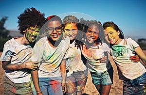 Friends fill your life with color. Shot of a group of teenagers having fun with colourful powder at summer camp.