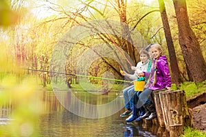 Friends fishing together with colorful fishrods