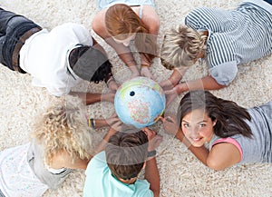 Friends on the floor examining a terrestrial world photo