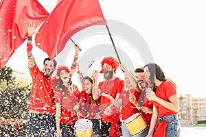 Friends football fans watching soccer match event at stadium - Young people having fun supporting club on sport world championship