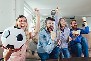 Friends or football fans watching soccer on tv and celebrating victory at home.Friendship, sports and entertainment concept