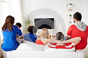 Friends or football fans watching tv at home