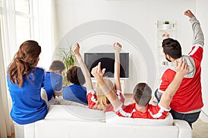 Friends or football fans watching tv at home