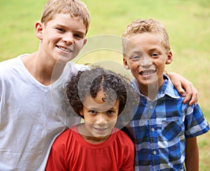 Friends forever. Portrait of three young kids standing outside.