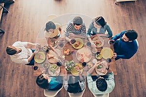 Friends forever! Top view of group of young people, who are having fun at home on the party with tasty food, drinks, jokes, enjoy