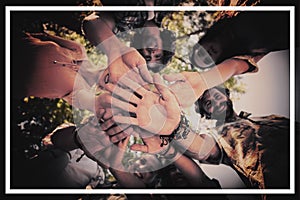 Friends forming a handstack in park