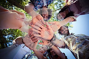 Friends forming a handstack in park