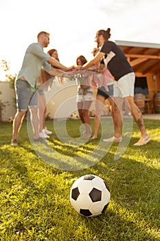 Friends gathered in circle during time out while playing football