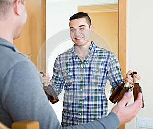 Friends gathering to drink beer at home