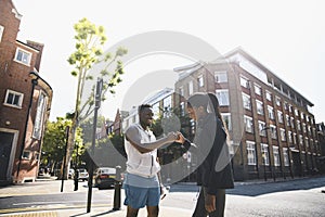 Friends giving a fist bump in London