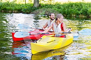 Friends going down river in sport canoe