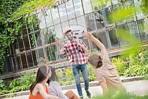 Friends greeting an acquaintance of young guitarist