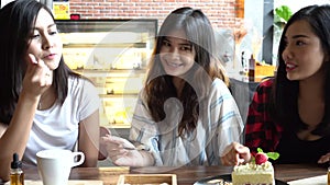 Friends group of Asian female enjoying a strawberry cake at cafe and restaurant