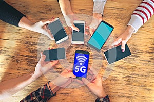 Friends group having fun together using 5G network connection on smartphones, Hands detail sharing wireless connection