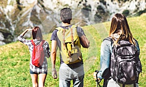 Friends group trekking on italian alps at afternoon - Hikers walking on mountain place - Wanderlust travel concept