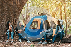 Friends Group of Young Asian women camping and resting at forest