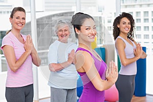 Friends with hands clasped standing in gym