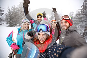 Friends with hands up on skiing