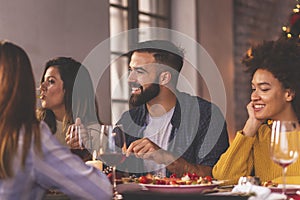 Friends having a conversation at Christmas dinner