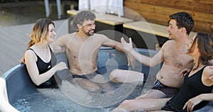 Friends having fun bathing at spa outdoors