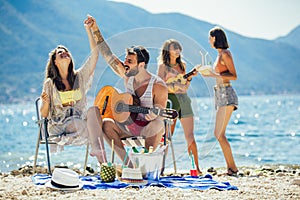 Friends having fun at the beach on a sunny day